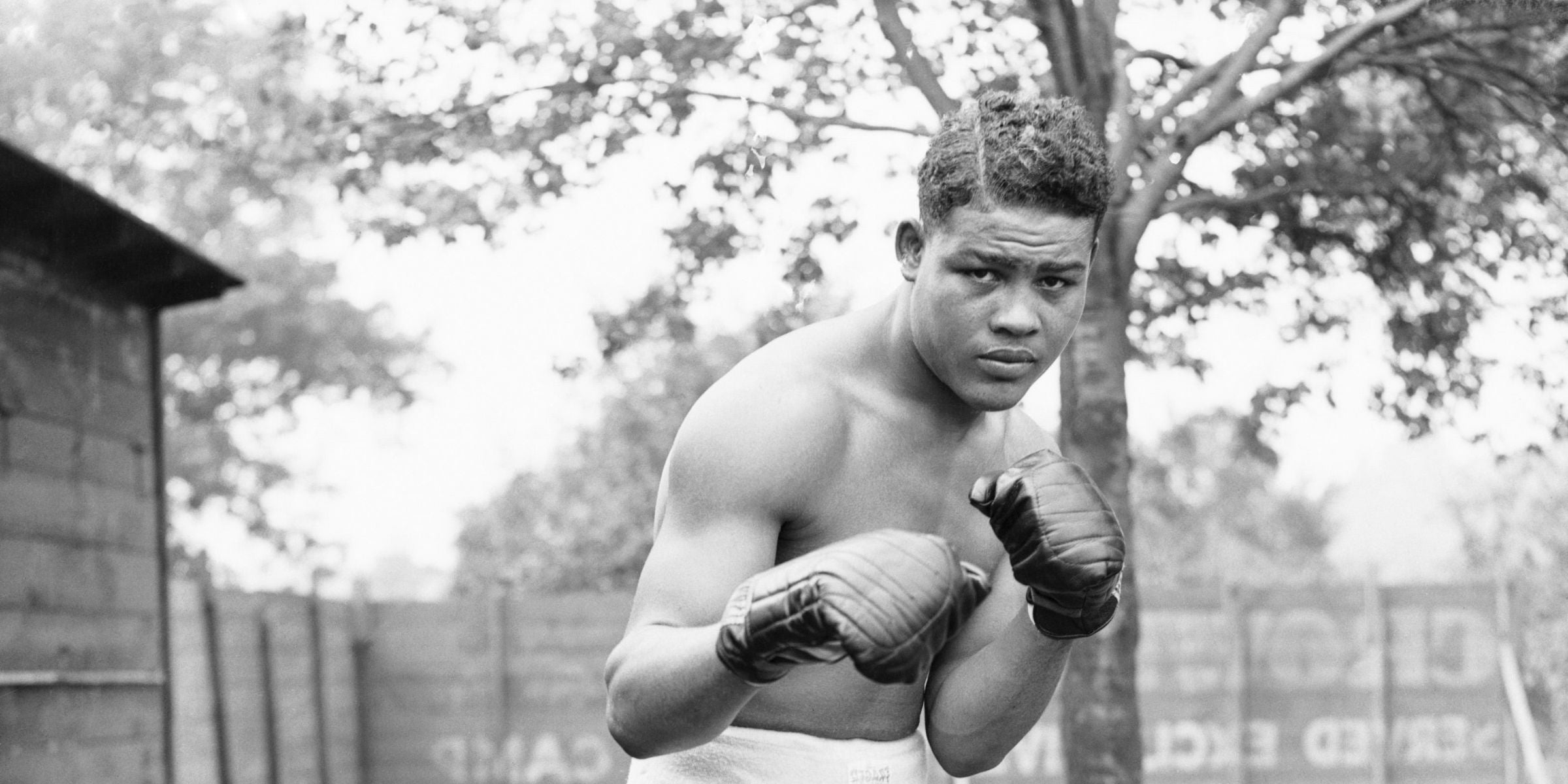 Joe Louis in a boxing stance in his garden